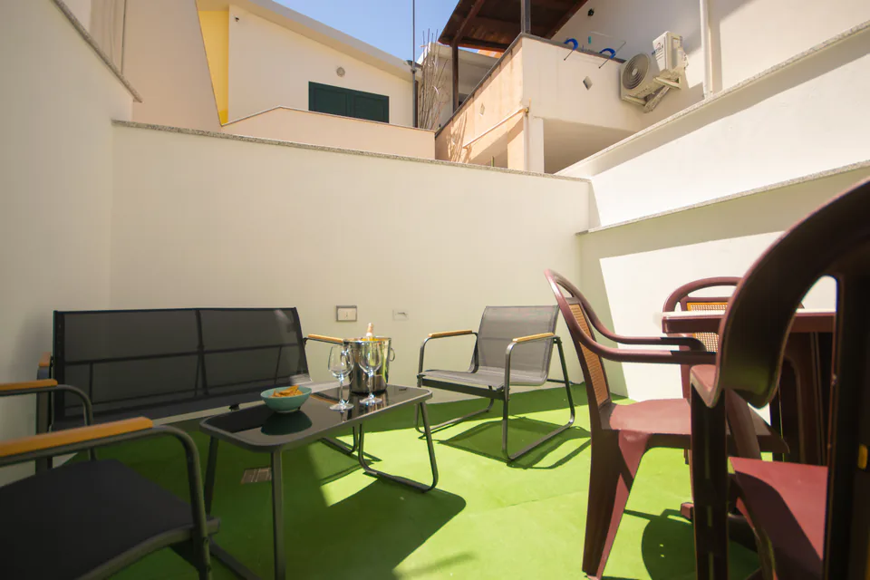 Il patio con il prato e le sedute